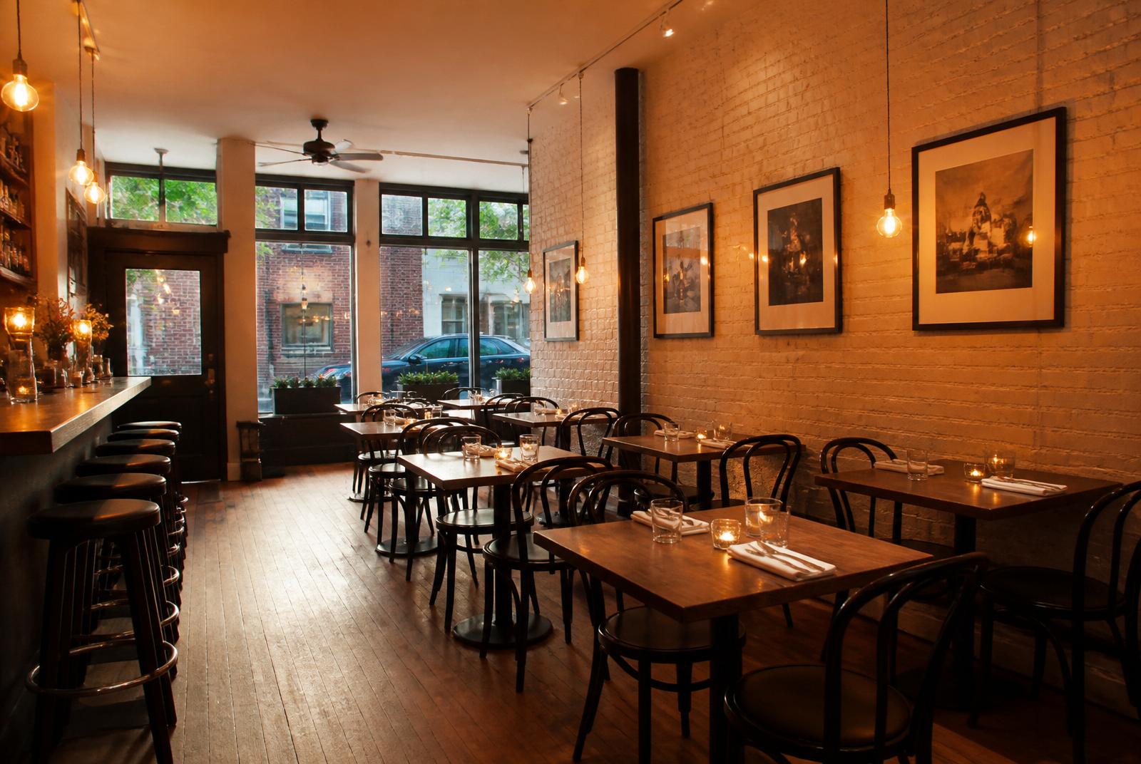 Upscale modern restaurant interior at twilight with city view